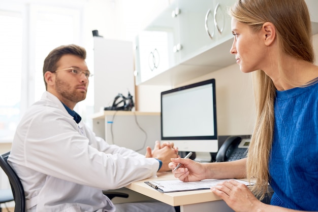 Young Woman Talking to Doctor