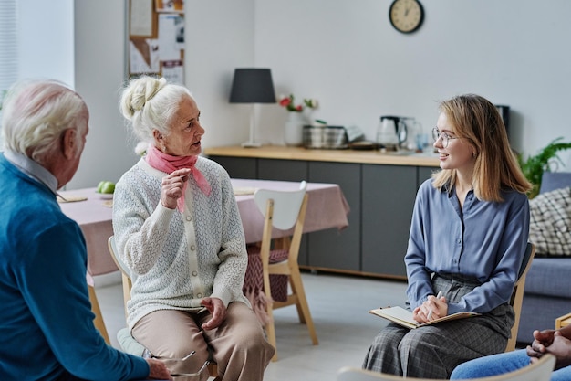 Young woman talking to elder people