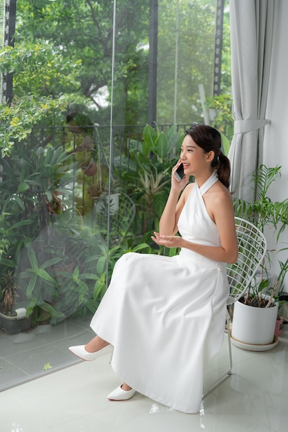 Young woman talking on the mobile in her hotel room