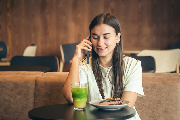 Young woman talking on the phone in a cafe copy space