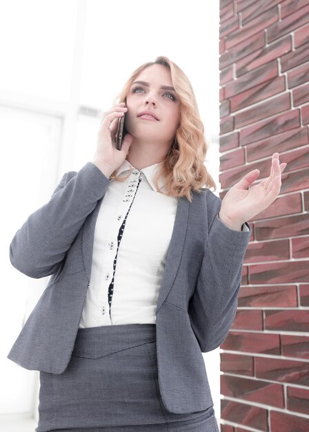 Young woman talking on the smartphone photo with copy space