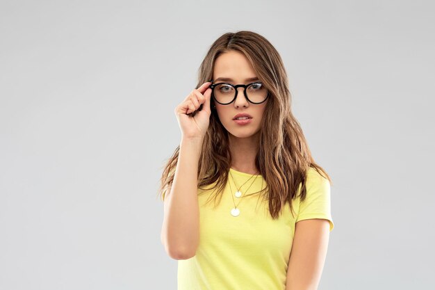 young woman or teenage girl in glasses