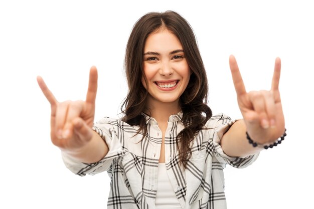 young woman or teenage girl showing rock sign