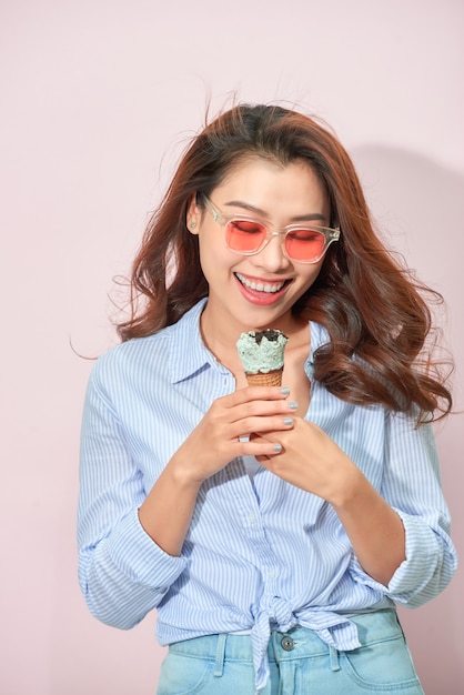 young woman or teenage girl in sunglasses eating ice cream