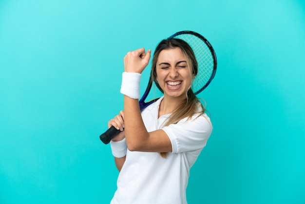 Young woman tennis player isolated celebrating a victory