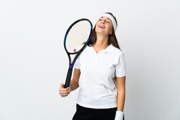 Young woman tennis player over isolated white background laughing