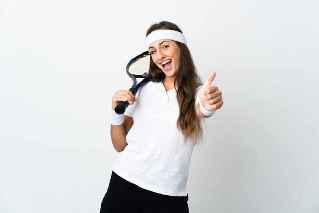 Young woman tennis player over isolated white wall with thumbs up because something good has happened