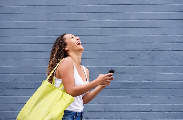 Young woman texting and laughing