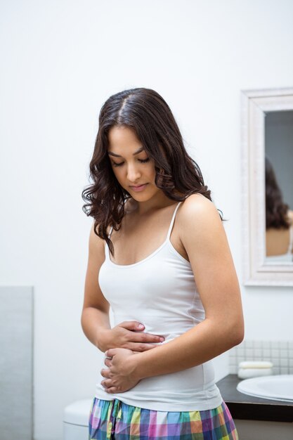 Young woman touching her belly