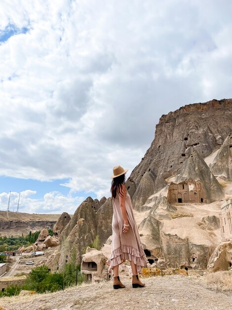 Young woman touring cave church in Cappadocia