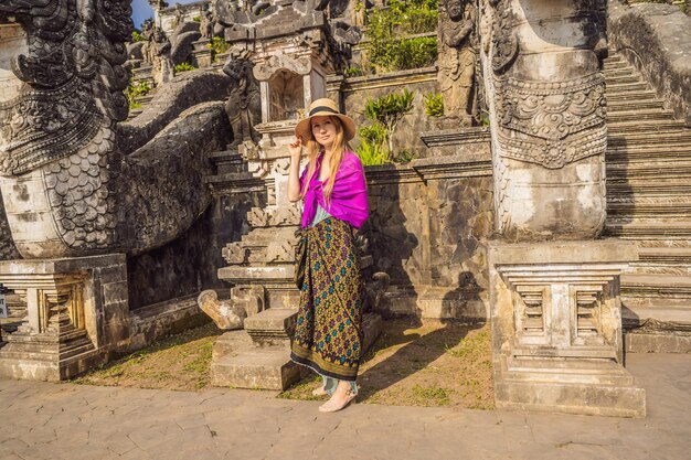 Young woman tourist on background of three stone ladders in beautiful pura lempuyang luhur temple