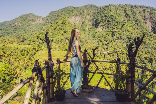 Young woman tourist on background of Tropical jungle of bali Forest and mountain Bali Travel Concept