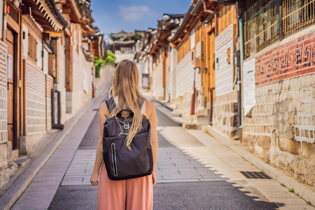 Young woman tourist in bukchon hanok village is one of the\
famous place for korean traditional houses have been preserved\
travel to korea concept