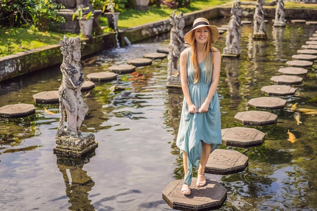 Young woman tourist in Taman Tirtagangga Water palace Water park Bali Indonesia