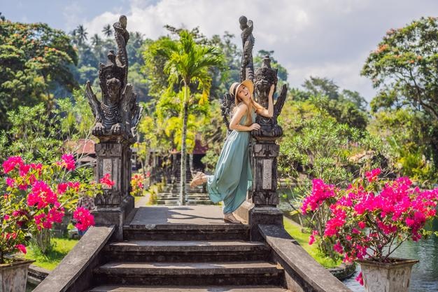 Young woman tourist in Taman Tirtagangga Water palace Water park Bali Indonesia