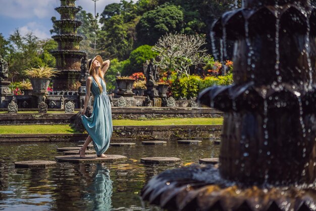 Young woman tourist in Taman Tirtagangga Water palace Water park Bali Indonesia