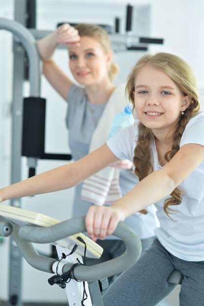 Young woman training with teenage daughter