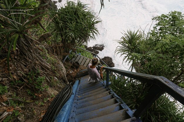 young woman traveler with a camera takes pictures of nature