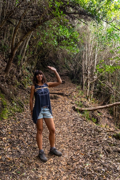 A young woman on the trekking trail of the Los Tinos natural park