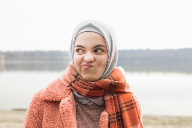 Young woman in trendy colors in making faces