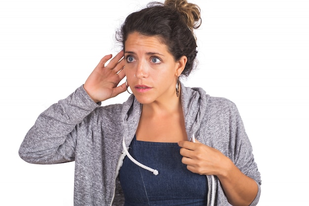 Young woman trying to listen something.