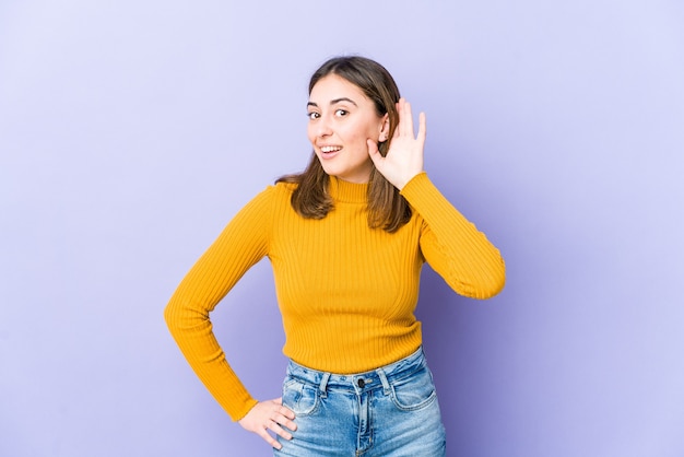 Young woman trying to listening a gossip