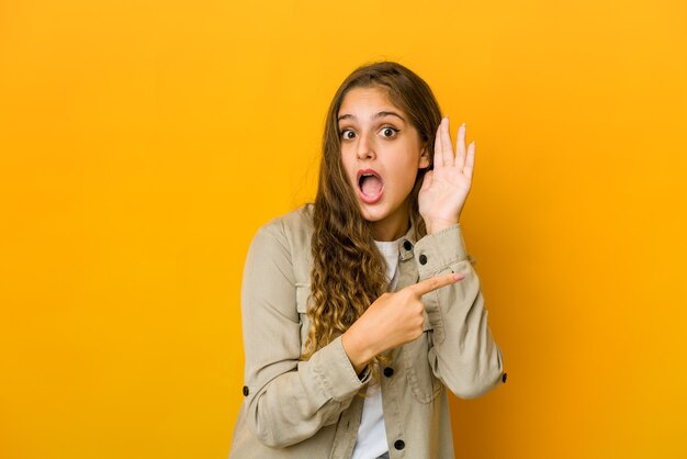 Young woman trying to listening a gossip