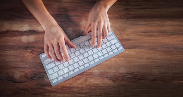 Young woman typing on the keyboard