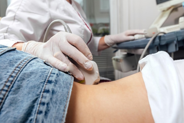 Young woman undergoing ultrasound scan in clinic