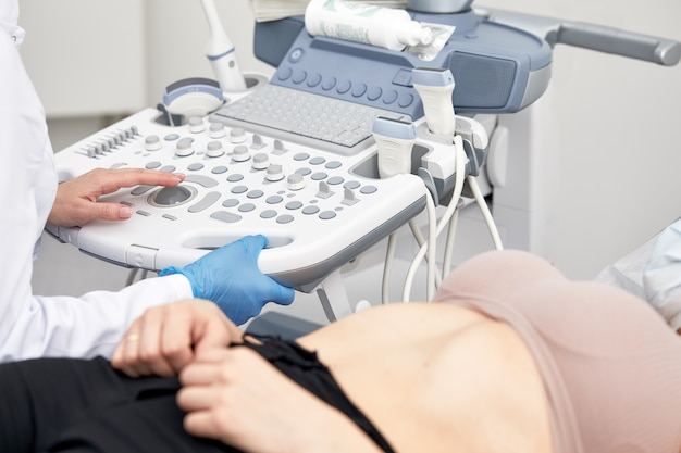 Young woman undergoing ultrasound scan in modern clinic.