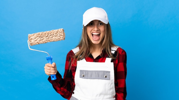 Young woman in uniform with painting roller