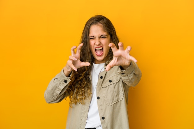 Young woman upset screaming with tense hands