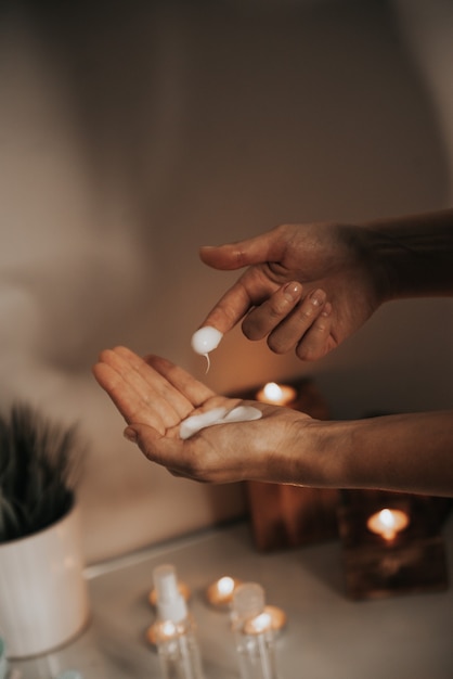 young woman uses body care cream