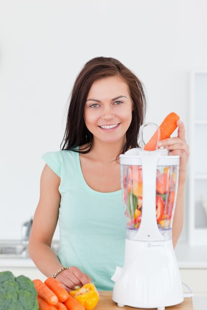 Young woman using a blender