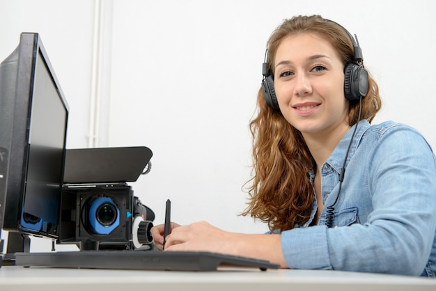 Young woman using computer for video editing