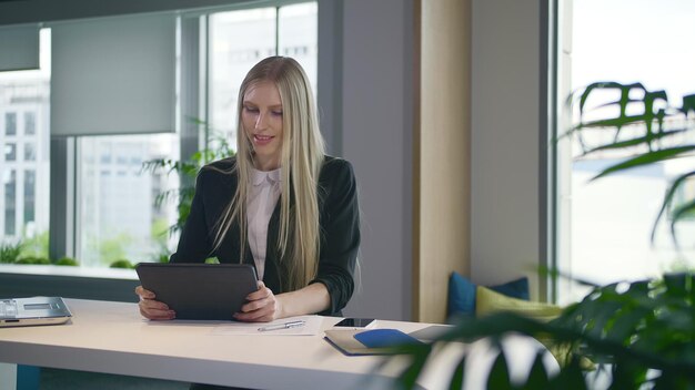 Young woman using digital tablet in office