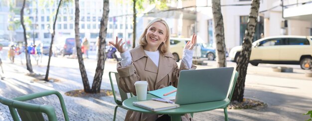 Young woman using laptop at cafe