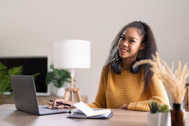 Young woman using laptop computer at office student girl\
working at home work or study from home freelance business\
lifestyle concept