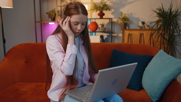 Young woman using laptop at home