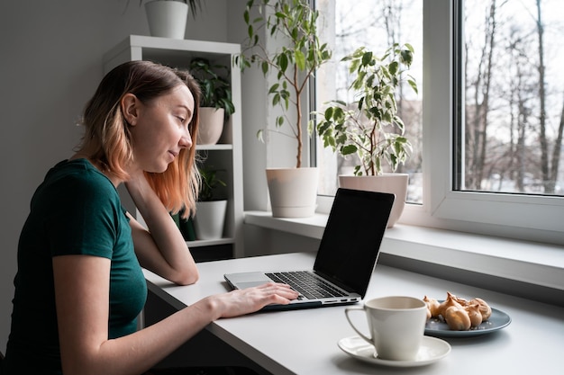 Young woman using laptop at home