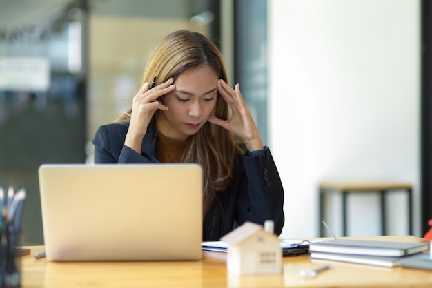 Young woman using laptop at office