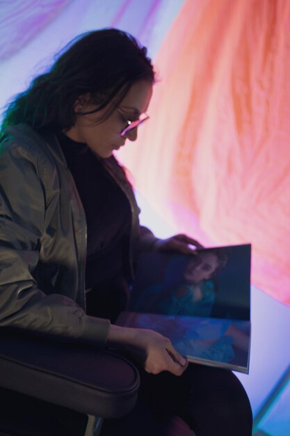 Young woman using laptop while sitting on bed at home