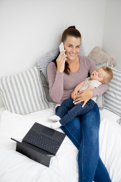 Young woman using laptop while sitting on sofa at home