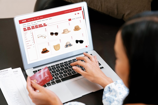 Young woman using laptop with credit card for internet banking blithe
