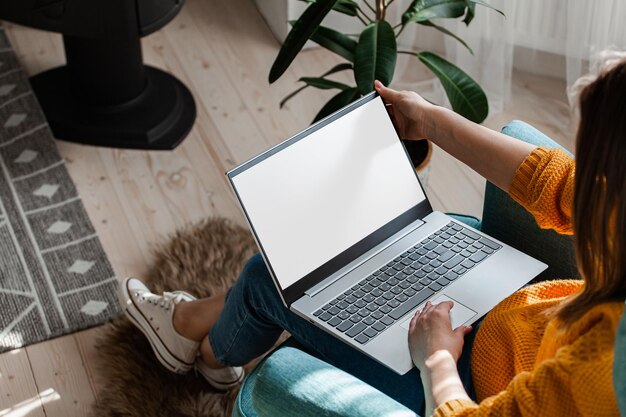 Young woman using laptop to work home remote work