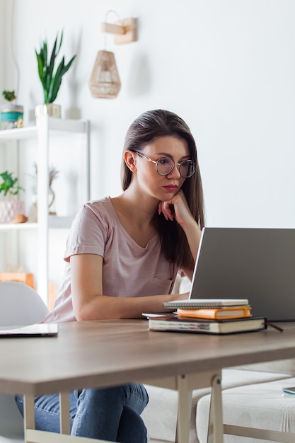 Young woman using laptop to work at home