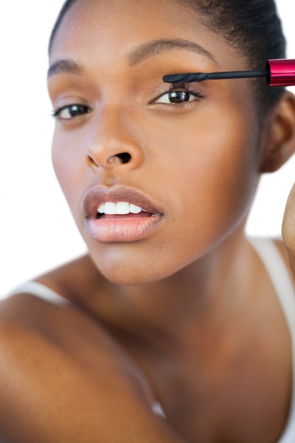 Young woman using mascara for her eyelashes