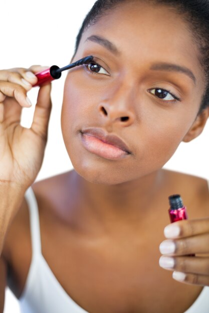 Young woman using mascara for her eyelashes