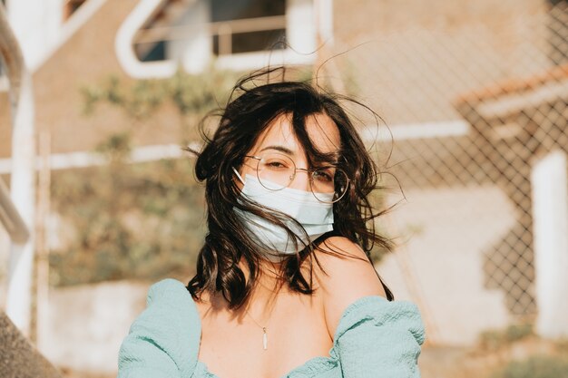 Young woman using a mask portrait during a summer day 