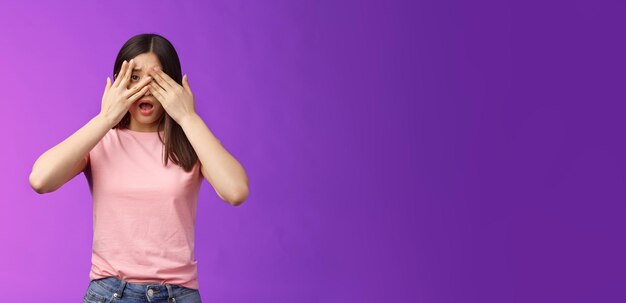 Young woman using mobile phone against blue background